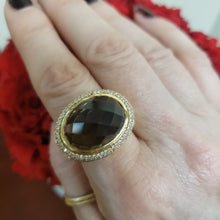 Load and play video in Gallery viewer, Beveled Cut Oval Smokey Topaz Domed Diamond Halo Ring in 14k Yellow Gold
